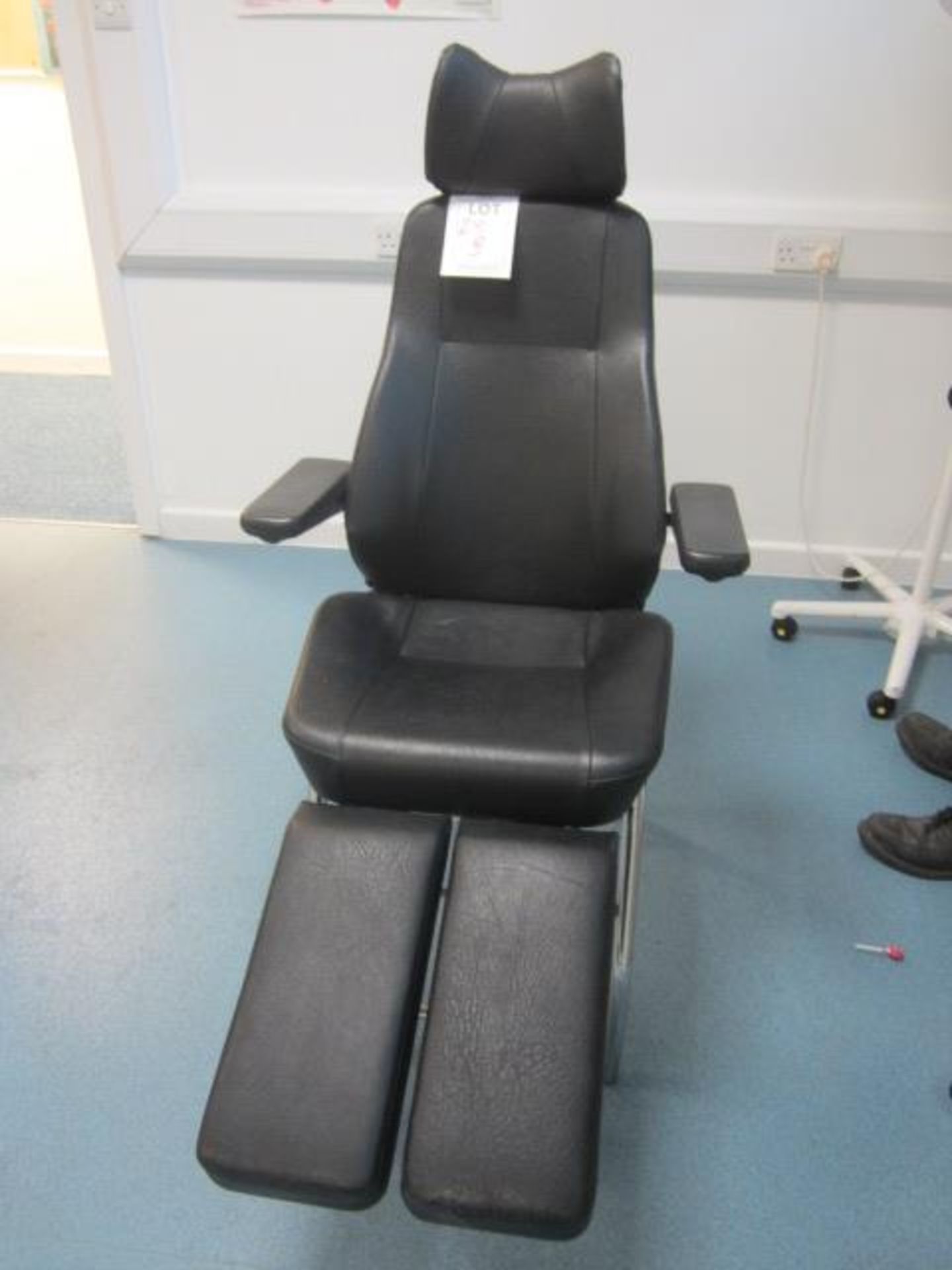 Leatherette examination chair with manual reclining back, adjustable leg rests