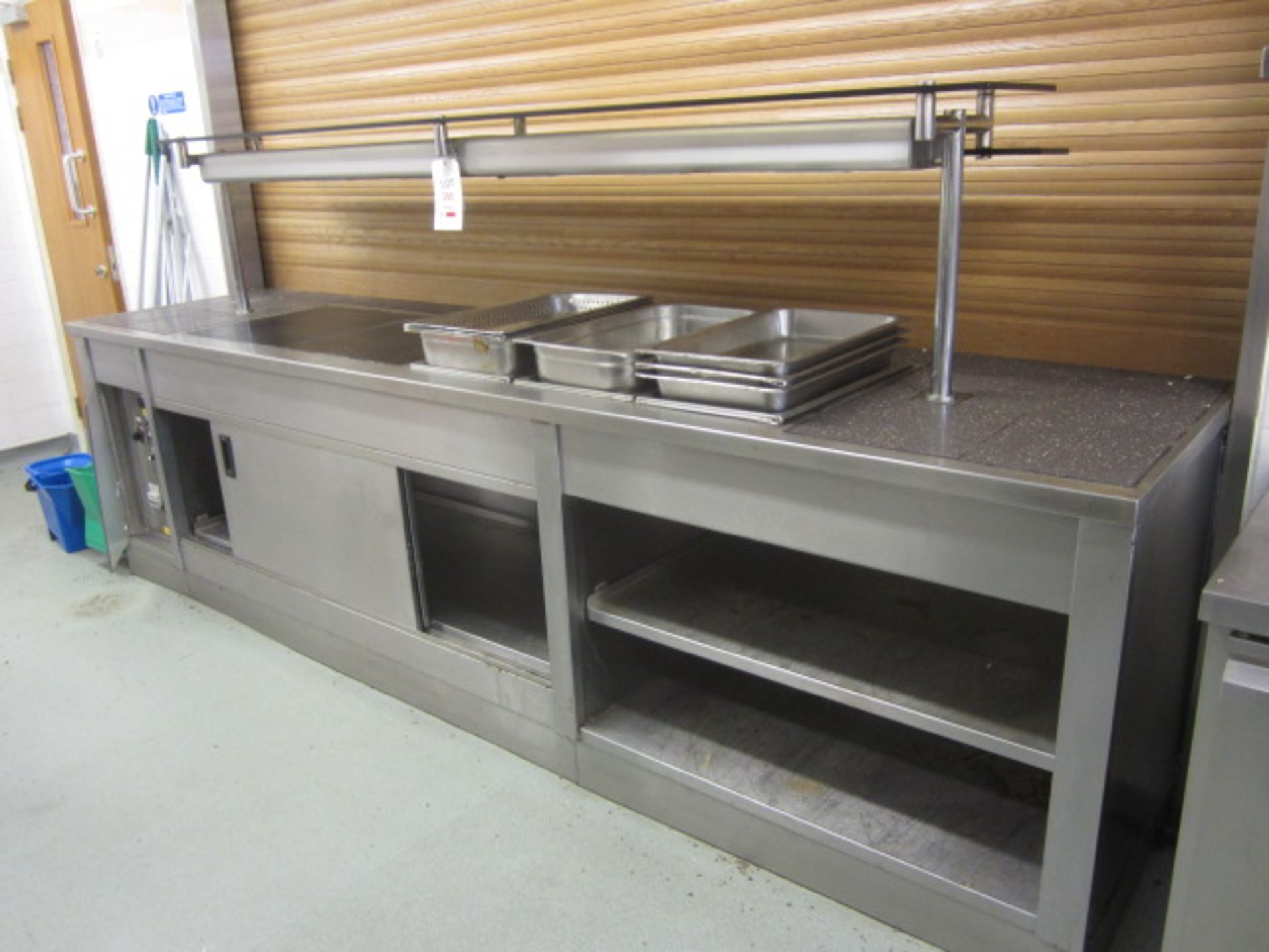 Unbadged stainless steel serving counter comprising 3 section Bain Marie, warming lamps, and hot