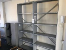 Four metal bookcases and a tambour front cabinet