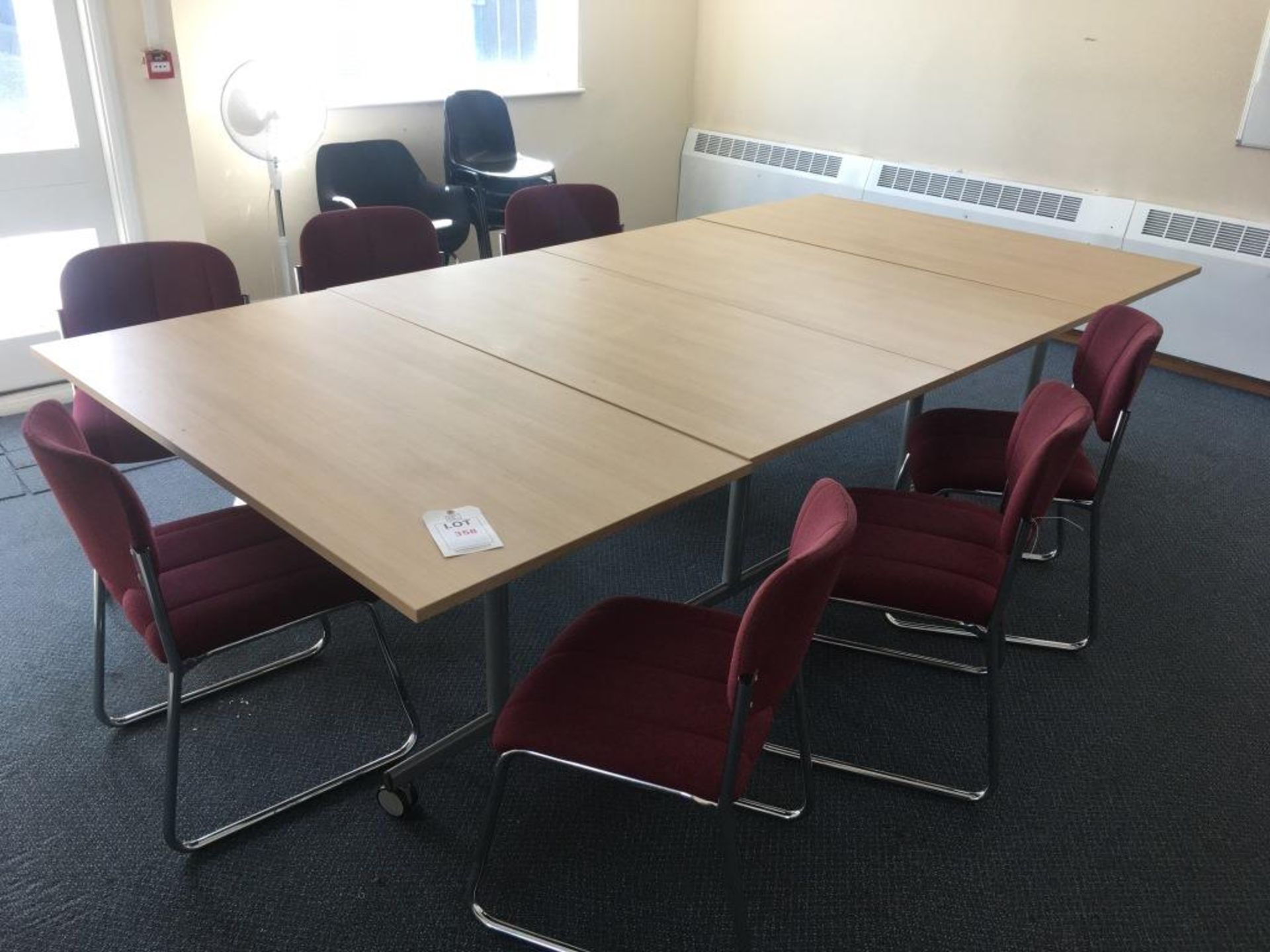 Four light wood veneer tables, twelve chairs and a floor standing fan