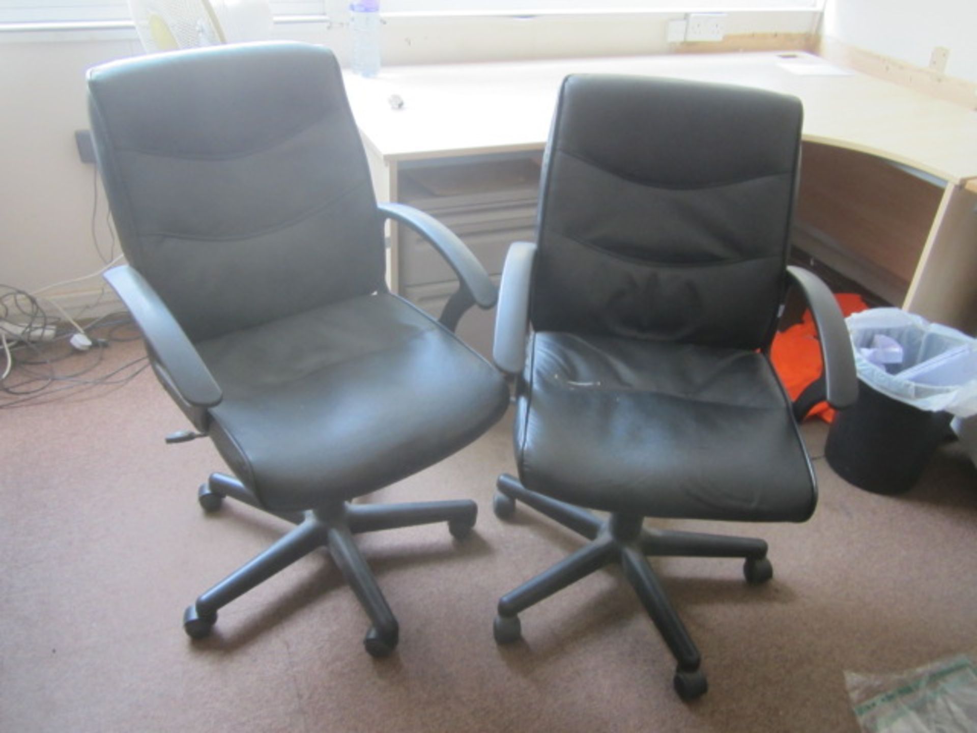 Two assorted leatherette upholstered swivel office chairs