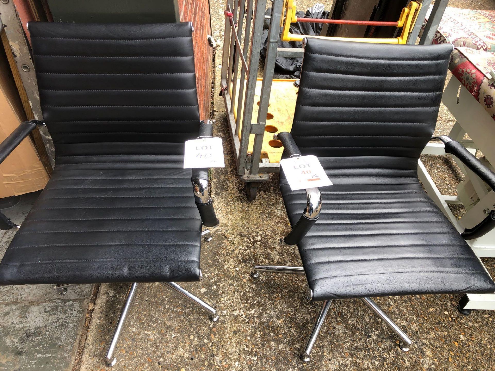 Two black leatherette & Chrome office chairs