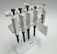 Various Thermo Scientific F1 clip tip manuel pipettes and stand