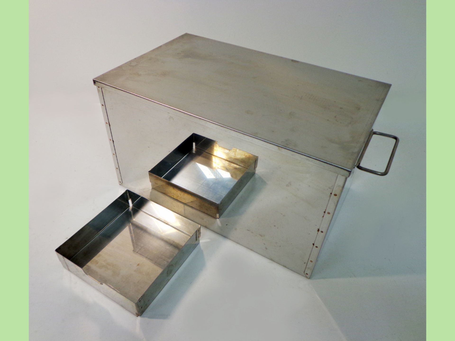 Stainless steel storage box with stainless steel lid and tray, and with polished surface finish. (