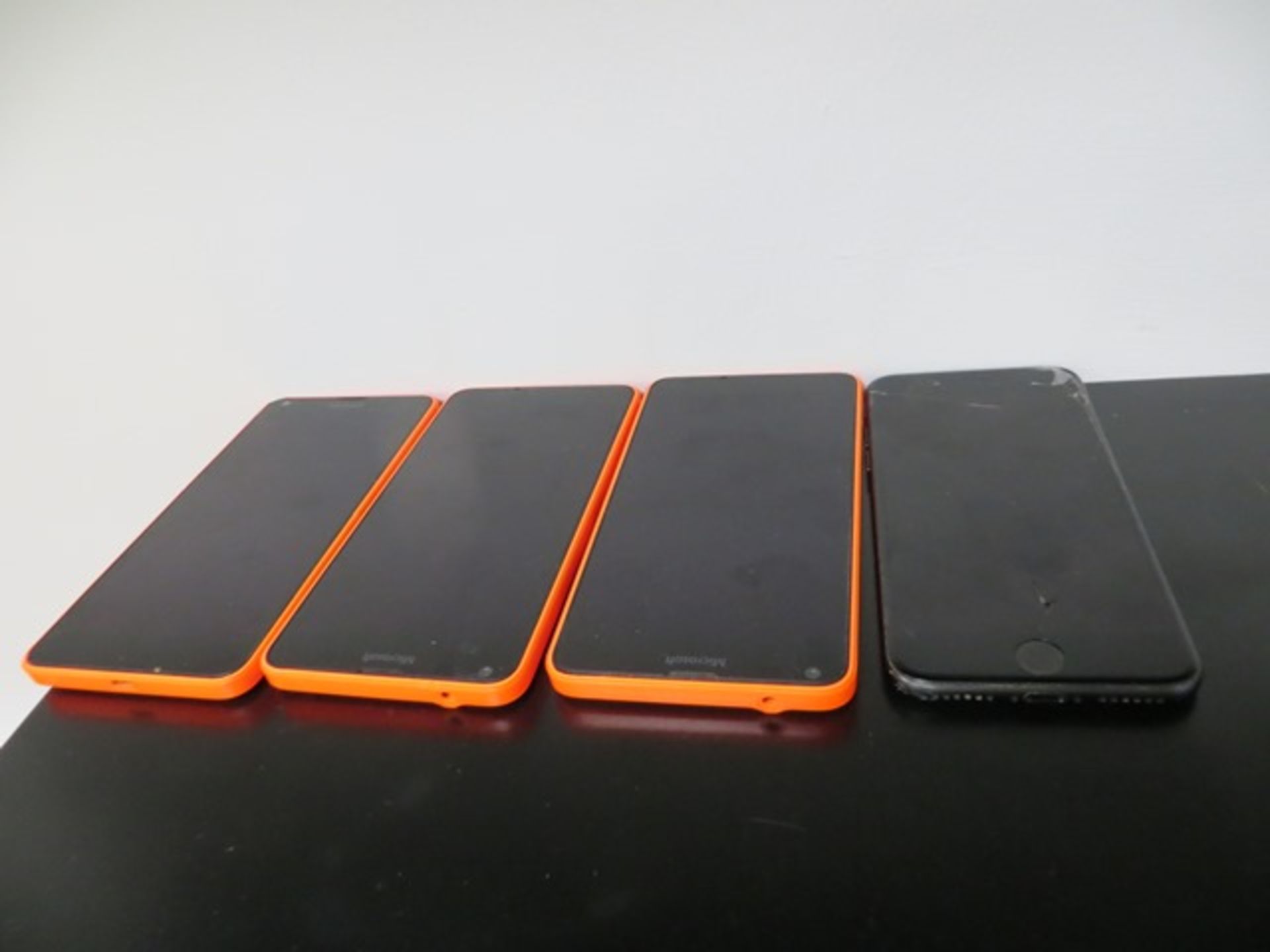 Three Microsoft Phones and an Apple iPhone (Cracked Screen)* This lot is located at Unit 15,