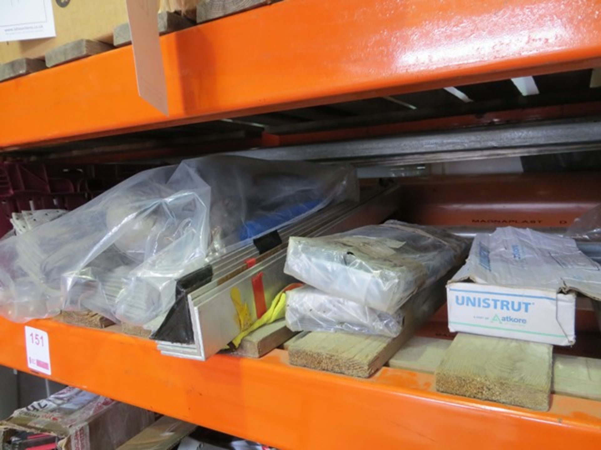 Three shelves of various nuts, washers, spill kits, angle iron, plates, threaded bar, brackets,