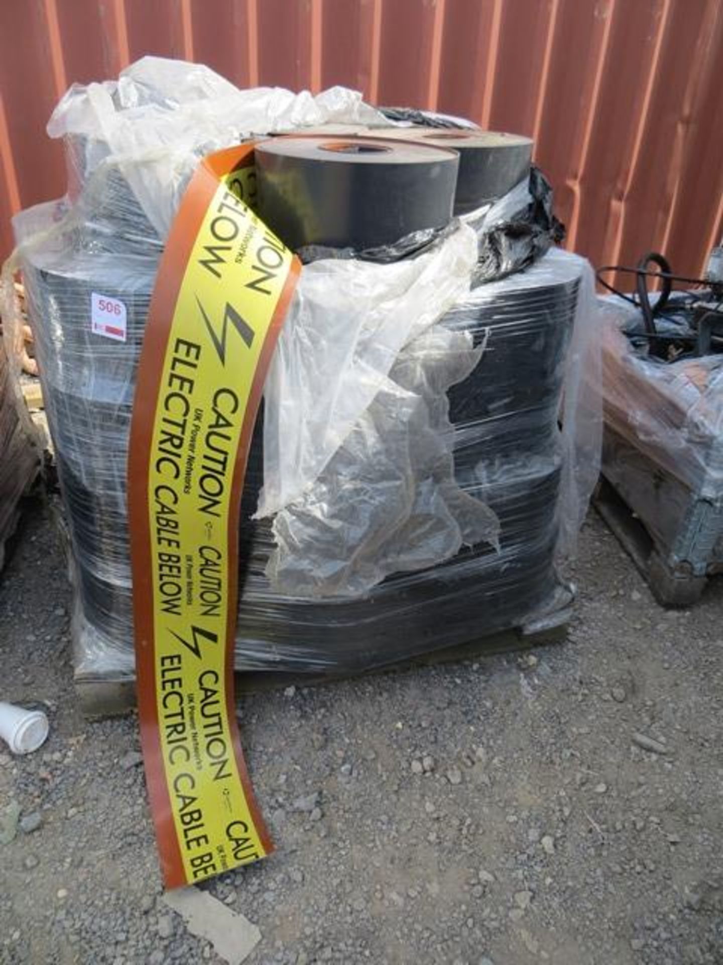 Two pallets of rubberised cable notification reels 'Caution Electric Cable Below' approx. 80 reels