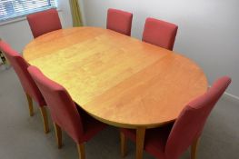 Light oak effect oval table, approx 2m in length, and 6 red cloth upholstered chairs (Please note: