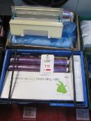 Two plastic crates and contents to include assorted cling film, wrap dispensers, etc.