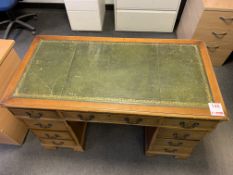 A 9 drawer partners desk with green top