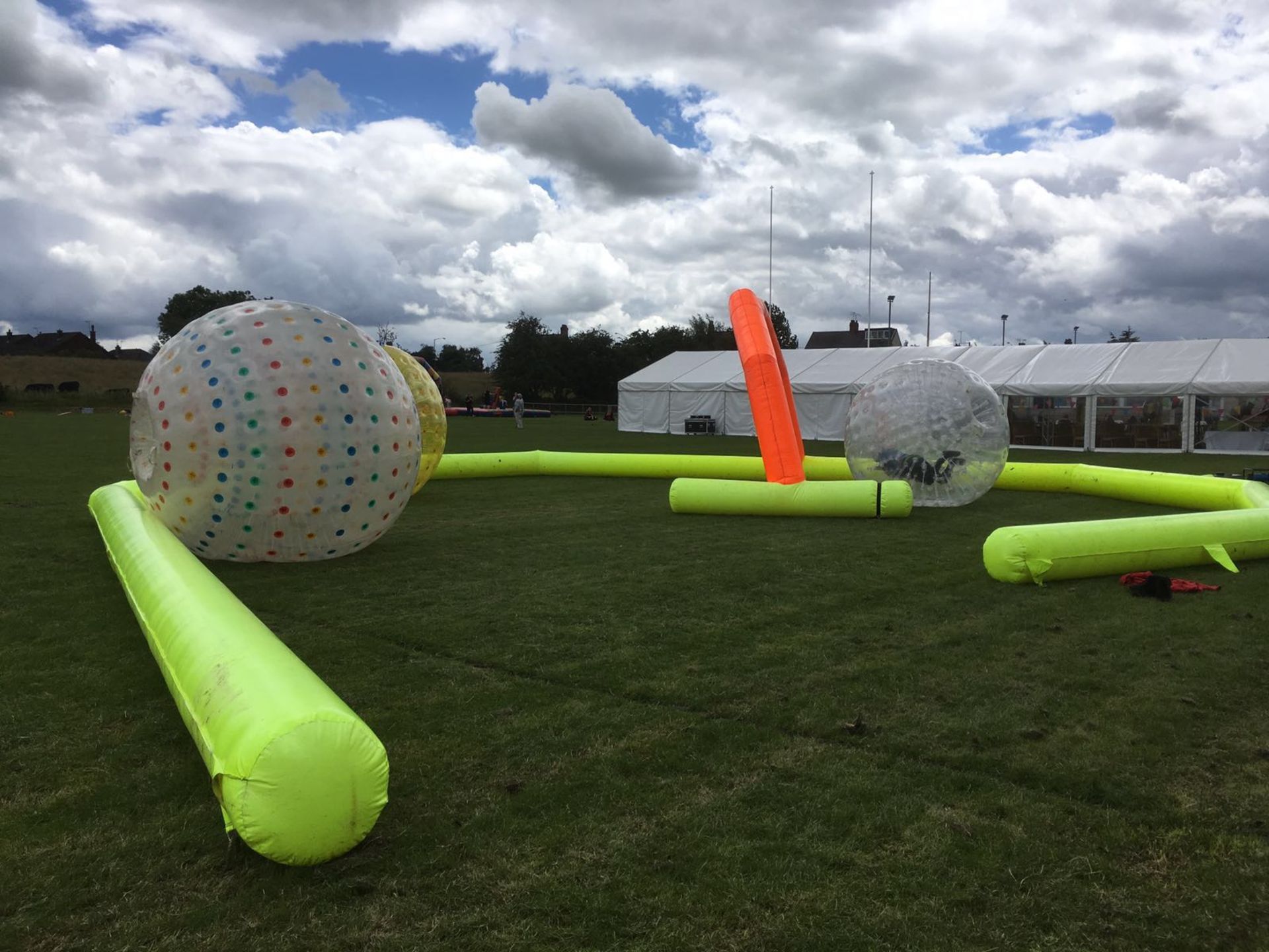 Land zorbs with inflatable track, thought to be 3