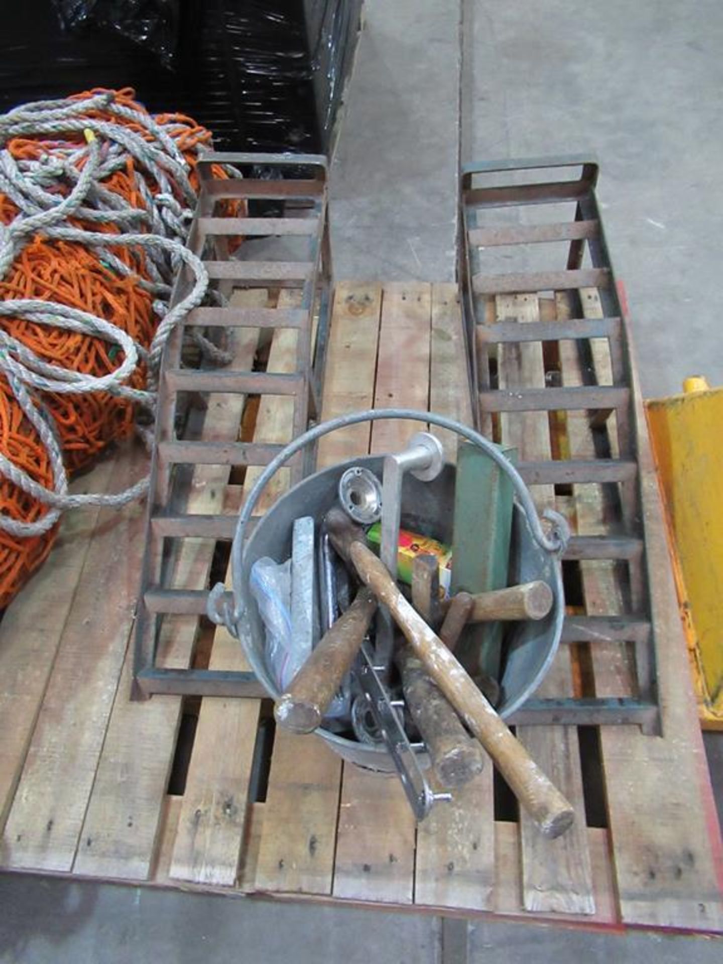 Pallet to contain bucket with various hand tools, two car ramps and goal netting