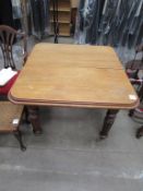 Solid oak dining table with insert leaf and brass castors