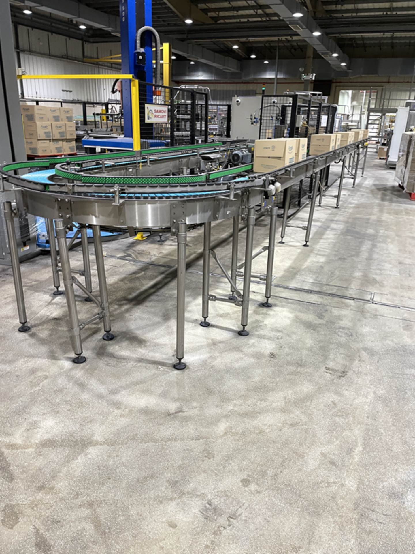 Two Sections of Powered Box Conveyor Feeding Pallets