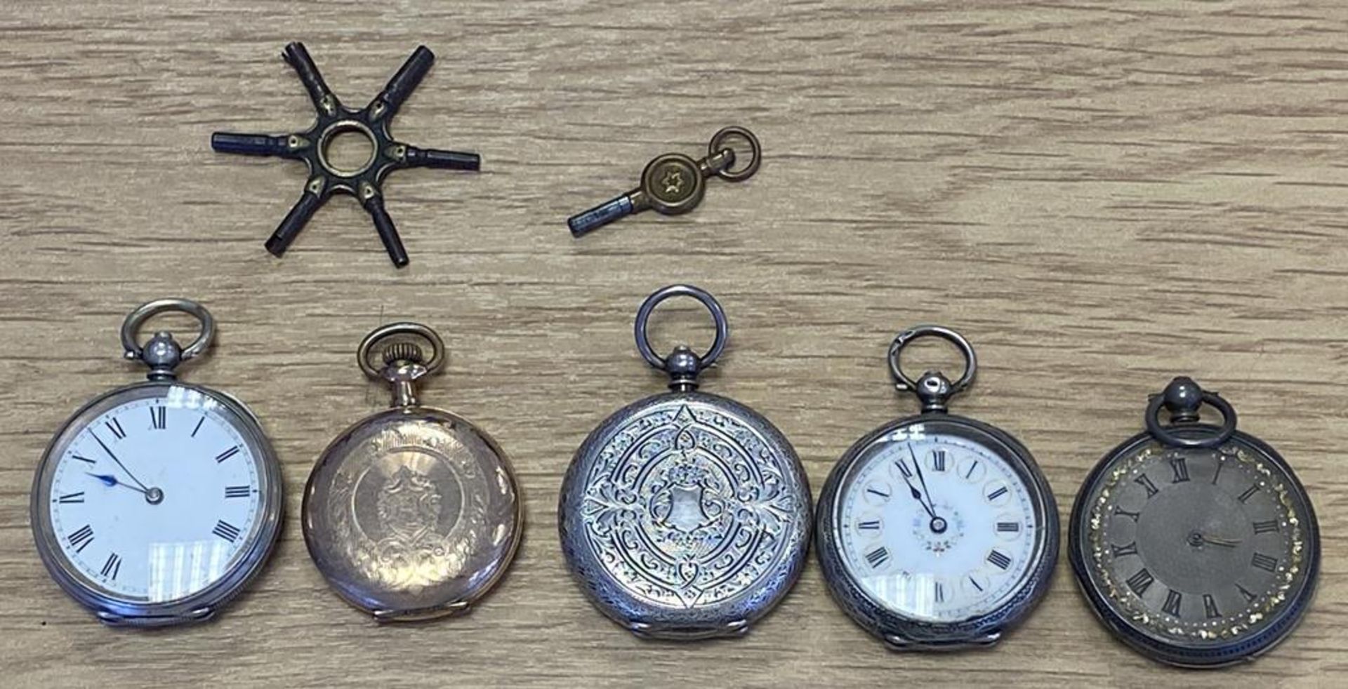 4 x Silver Fob Watches and a Yellow Metal Fob Watch marked "Crown Watch Company"