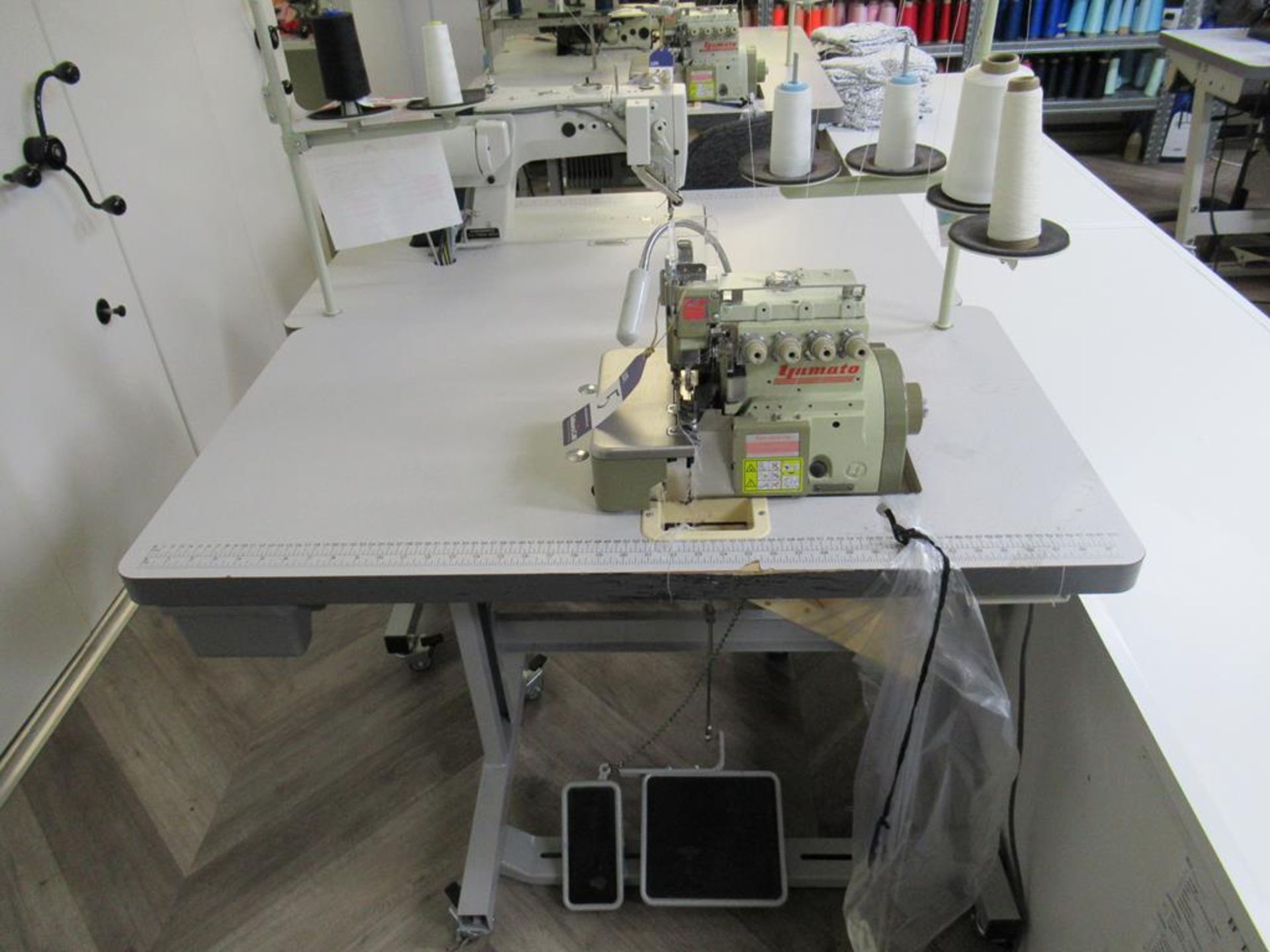 A Yamato CZ6120- Y6DF Needle 4 Thread Overlock Industrial Sewing Machine Complete with Table