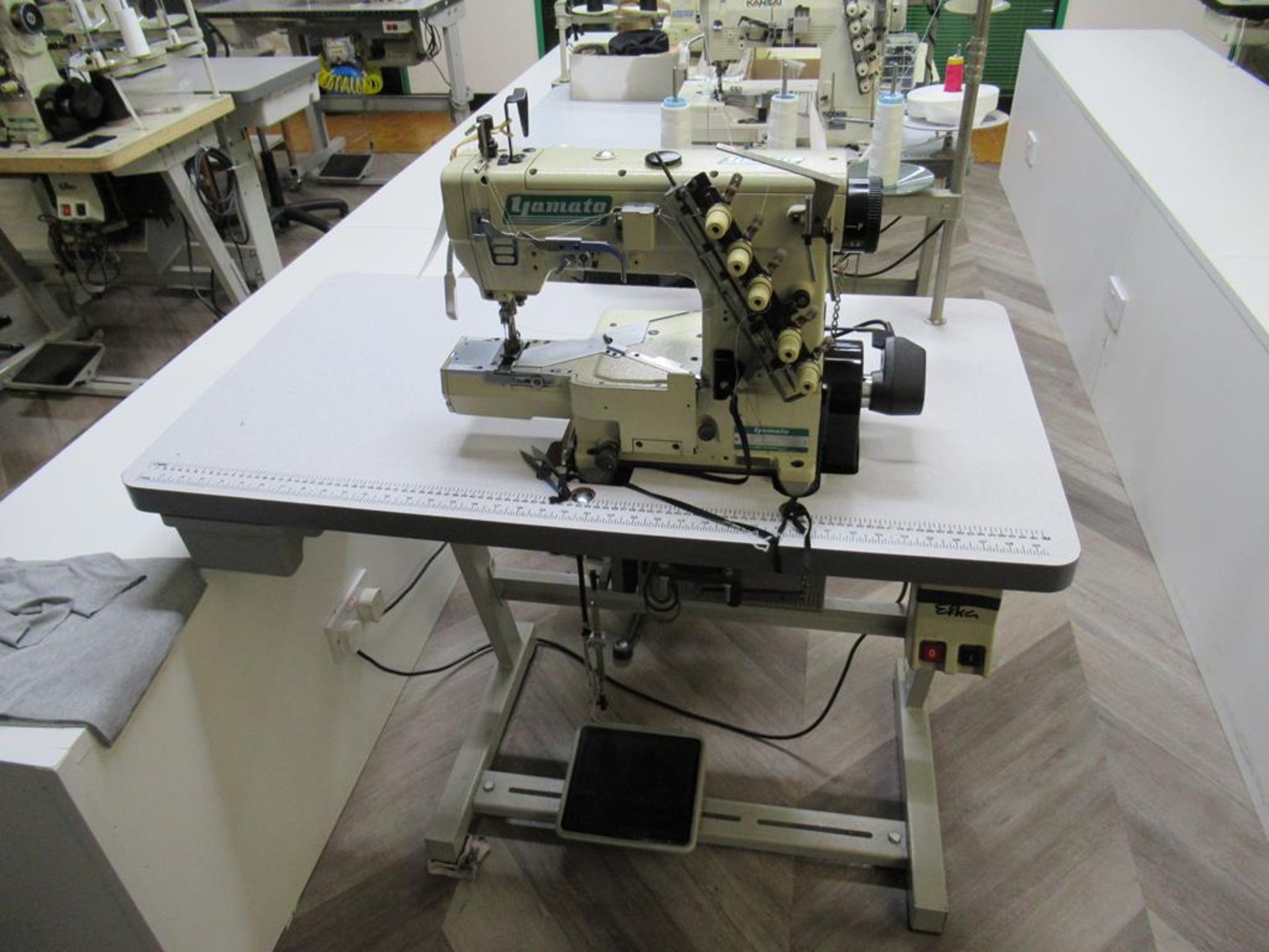 A Yamato VC-2730-15GM 3 Needle Top and Bottom Cover stitch Industrial Sewing Machine with Thread Tri