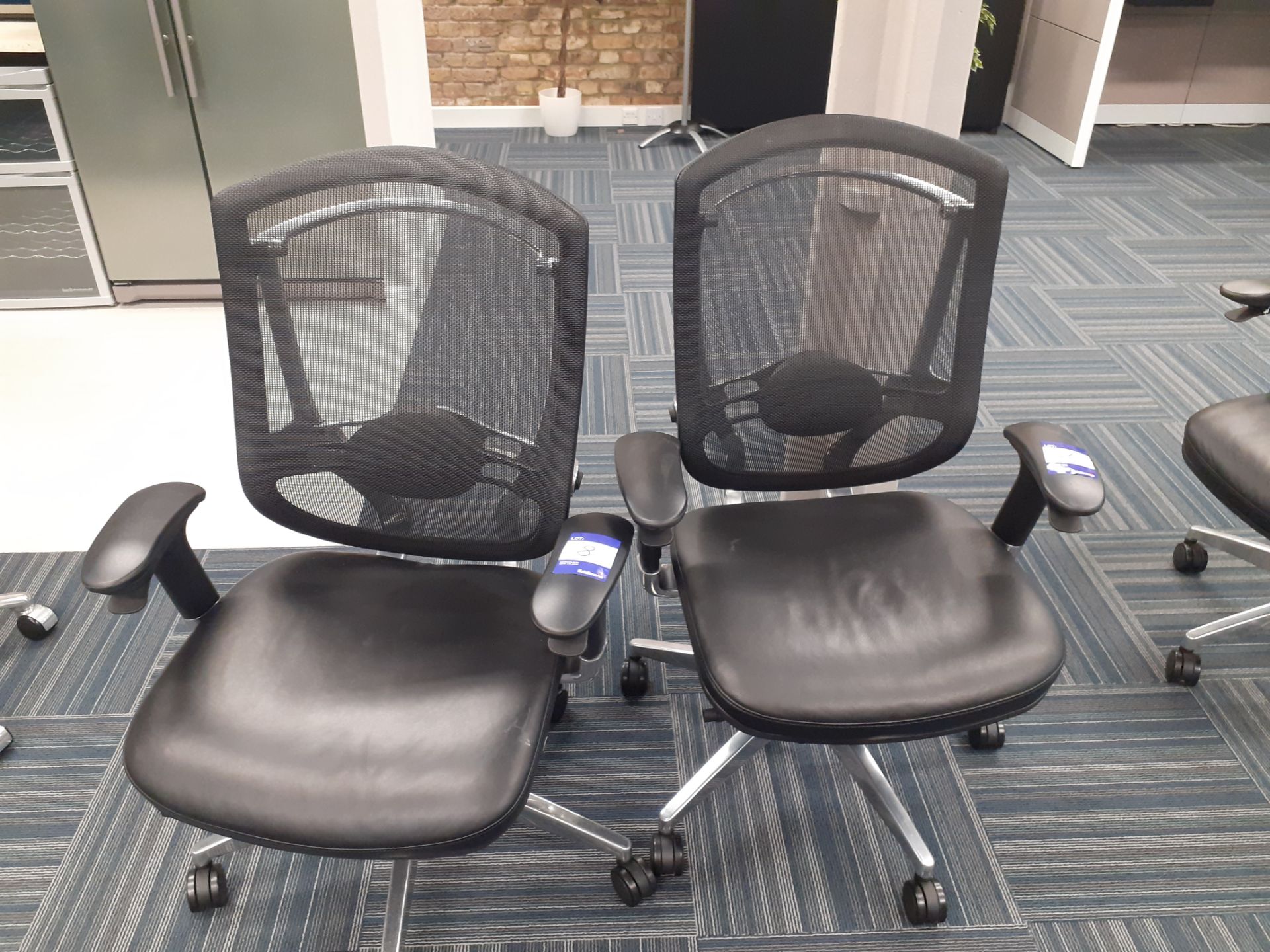 2 x Mobile swivel elbow chairs, leather seat with mesh back. Location – London. Viewing strongly