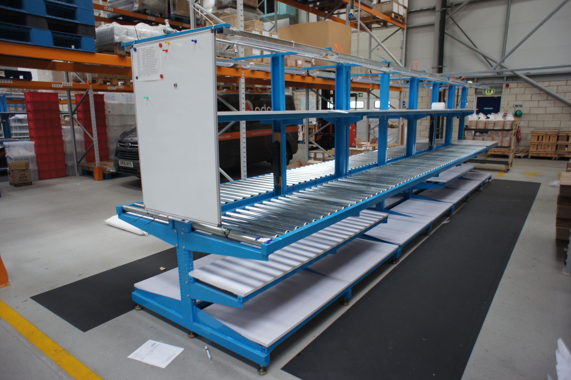 Double sided assembly station, comprising 2 x various worktables, and 2 x lengths of roller conveyor
