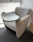 Upholstered mobile ergonomic armchair, with integrated side table