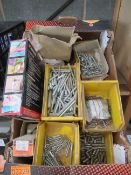 A box of various screws and glue gun sticks