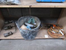 a 3 head gas burner and bucket of nails