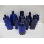 Box of Cobalt blue glass bottles including: Botterhils Grimsby Hair restorer, Dr Rookes Pale Newfoun