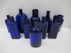 Box of Cobalt blue glass bottles including: Botterhils Grimsby Hair restorer, Dr Rookes Pale Newfoun