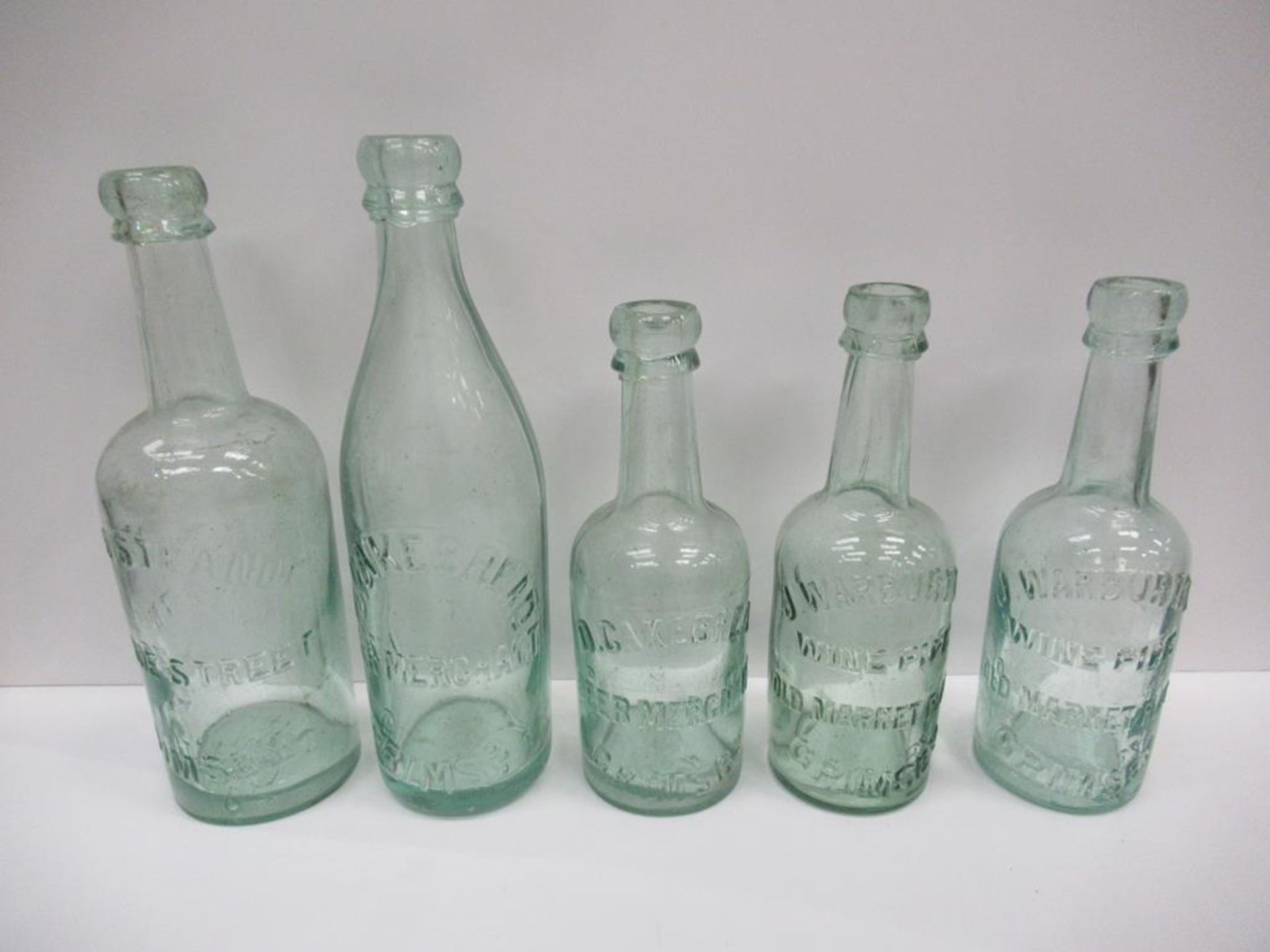 5x Grimsby bottles including Otto Strand (1), D. Cakebread Beer Merchant (2) and J. Warburton Wine P