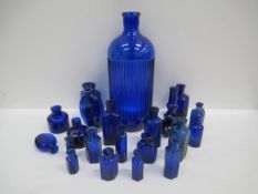 Box of Cobolt blue glass bottles including 'Not To Be Taken' bottles