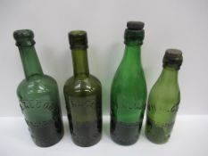 4x Grimsby J.H. Alcock wine merchants coloured bottles (2x matching lids)