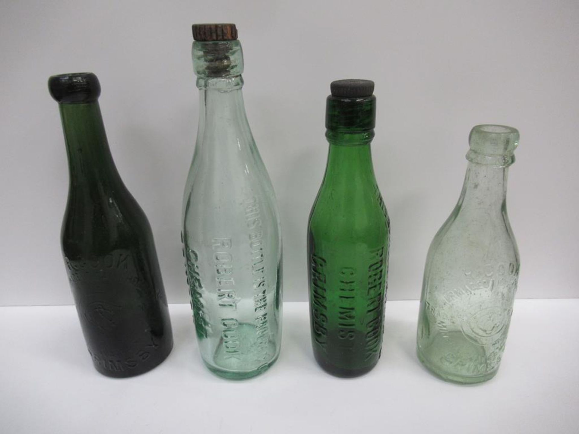 4x Grimsby R. Cook (2)/ Robert Cook (2) bottles (2x coloured) (2x with stoppers)