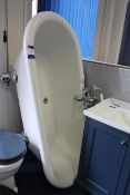 Free Standing bath in white plastic, with chrome feet, chrome mixer taps, and shower attachment,