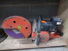 A Petrol Skill Saw & Spare Cutting Disks (Brand Unknown)