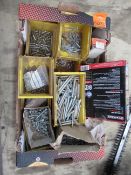 A box of various screws and glue gun sticks