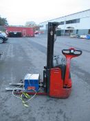 A Linde L12 pallet truck with charger