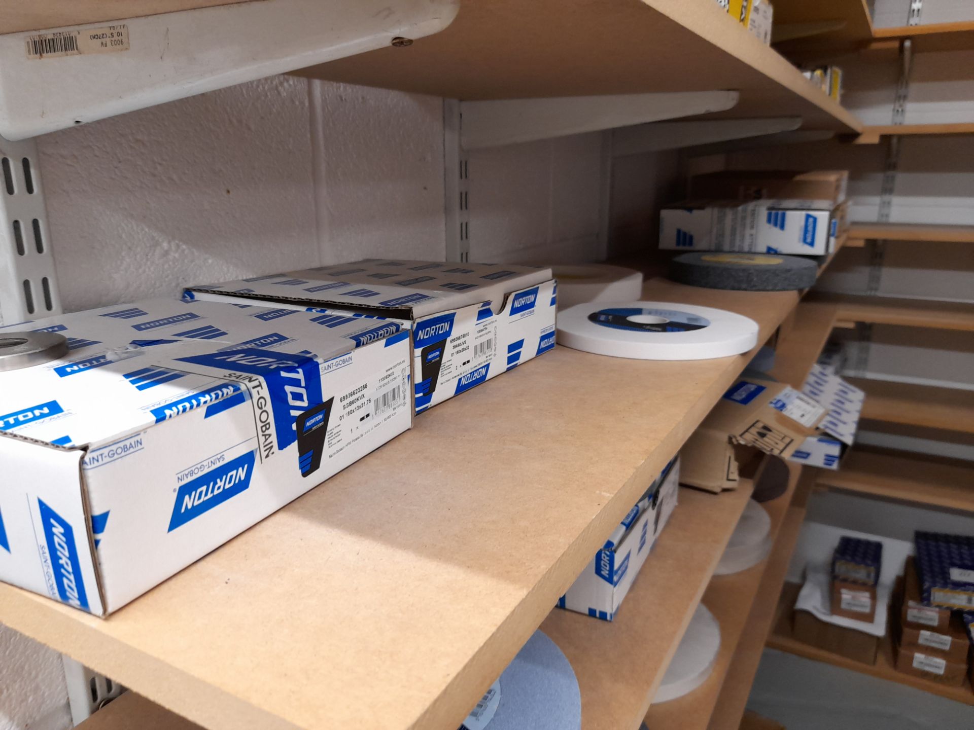 Quantity of various Norton grinding wheels as photographed (Shelving not included)