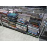 A shelf conraining books of assorted themes