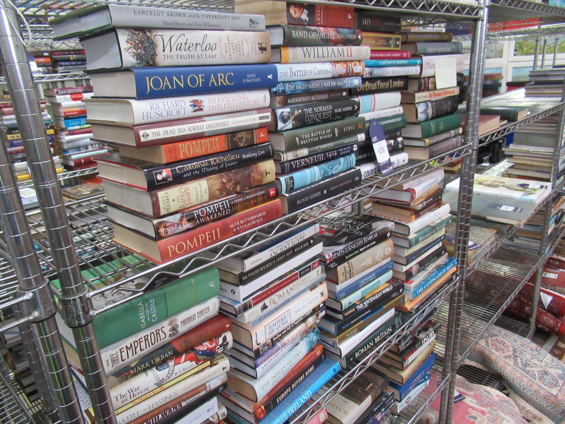 Two shelves containing an assortment of British and Global history themed books, to include 'Blood S