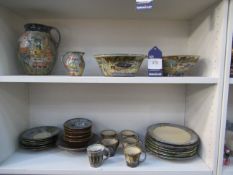 Two shelves of Peter and Margaret Thomas Tableware