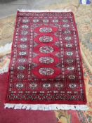 2 x Bokhara Oriental Rugs (sizes 97cm x 62cm) and another rug (124cm x 75cm)