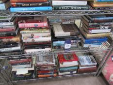 Two shelves containing an assortment of British and Global history themed books including 'Medival W