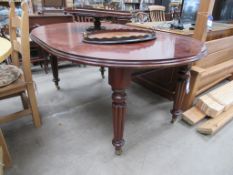 An Extending Mahogany Table on Castors