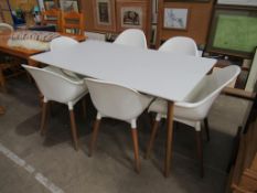 A White Ikea Table and Six Matching Chairs