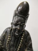 A Heavy Bronze Figure of East Asian Man Standing on a Chinese Dragon Head (78cm tall)