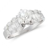 A DIAMOND DRESS RING in 18ct white gold, set with a central round cut diamond of 1.01 carats,