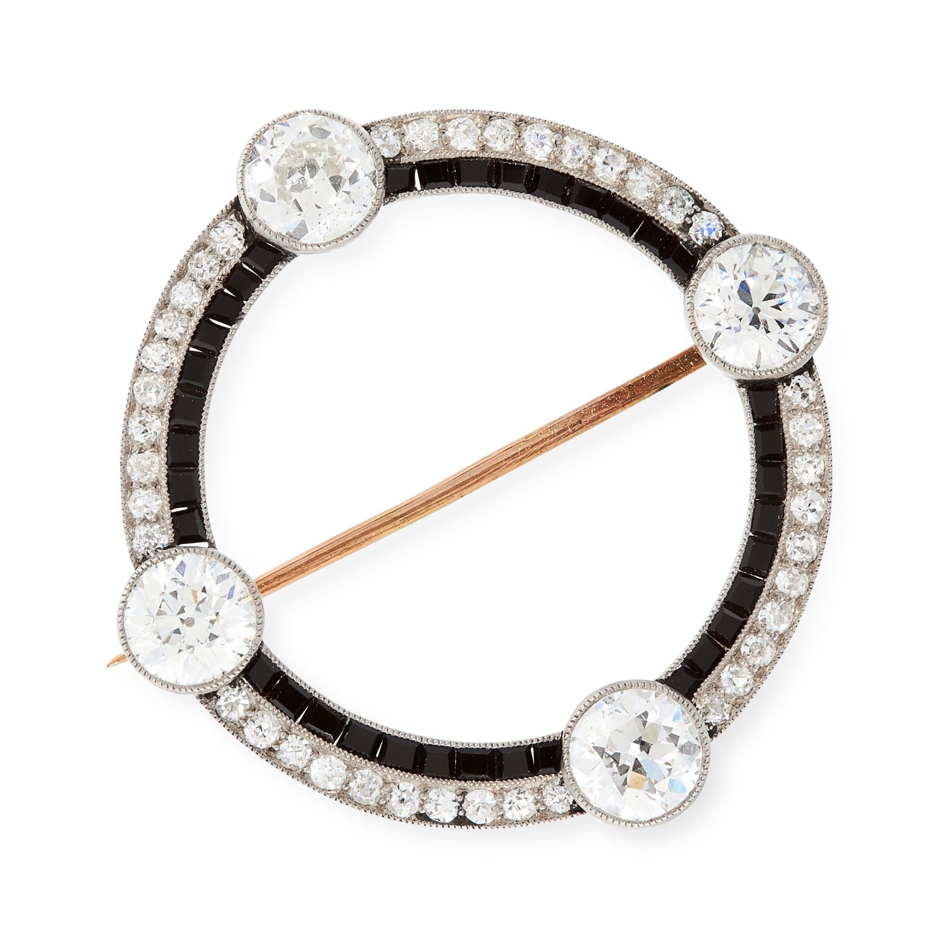 AN ART DECO DIAMOND AND ONYX BROOCH, EARLY 20TH CENTURY of circular design, set with four