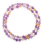 AN AMETHYST AND ROCK CRYSTAL BEAD NECKLACE in yellow gold, comprising a single row of polished