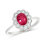 A RUBY AND DIAMOND DRESS RING in 18ct white gold, set with an oval cut ruby of 1.20 carats, within a