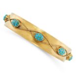 AN ANTIQUE TURQUOISE BANGLE, 19TH CENTURY in yellow gold, the band applied with eight berry